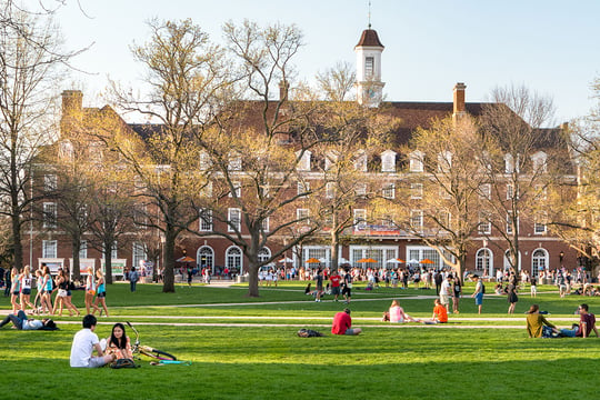 education_website_0001_grounds management-attract and retain students-students walk and sit outside