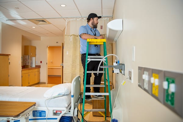 facilities maintenance worker in patient room