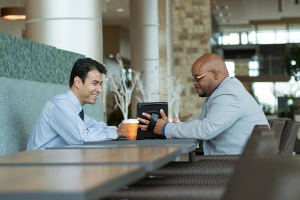 Two businessmen analyze data