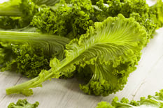 mustard greens wood background