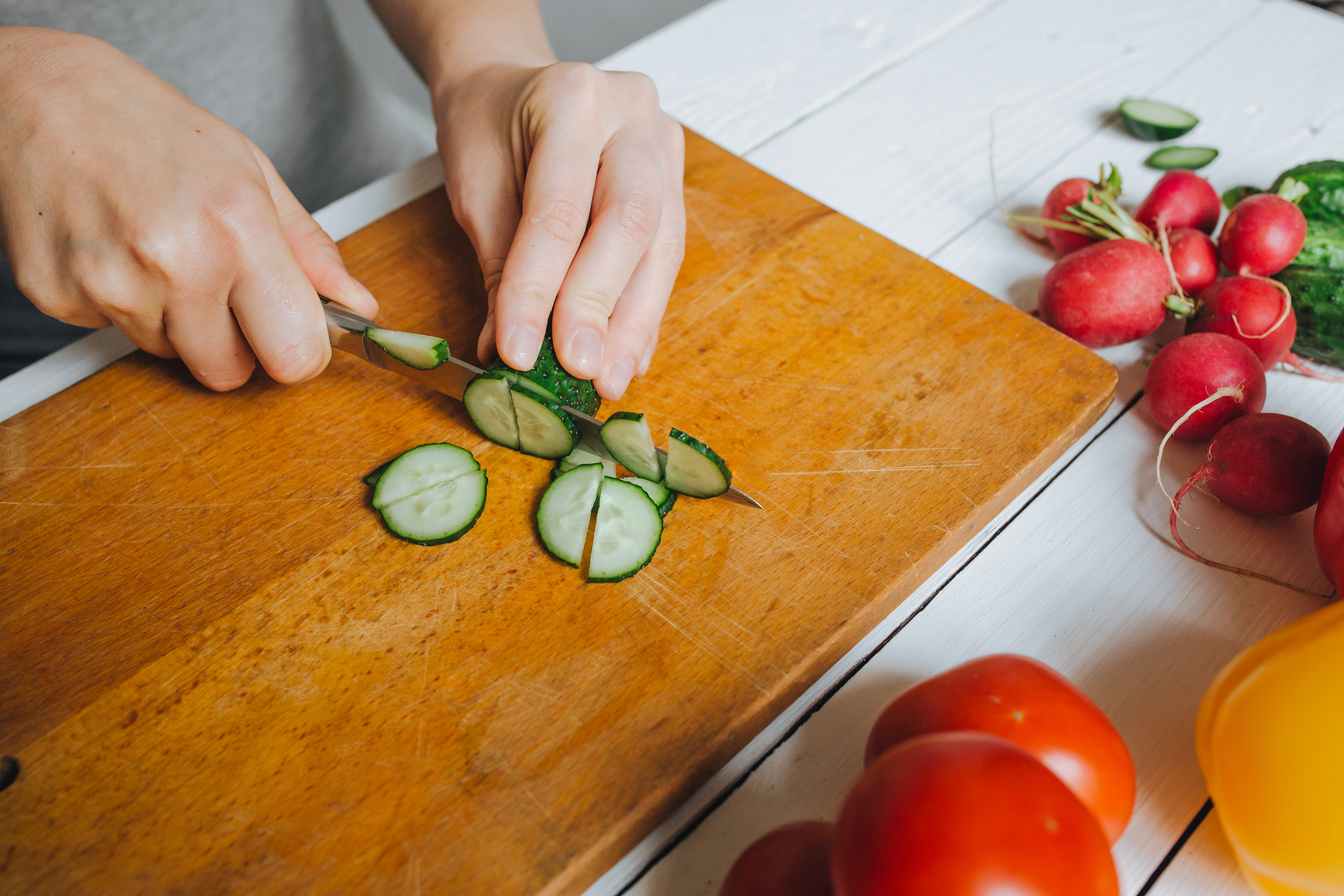 woman cutting cucmbers